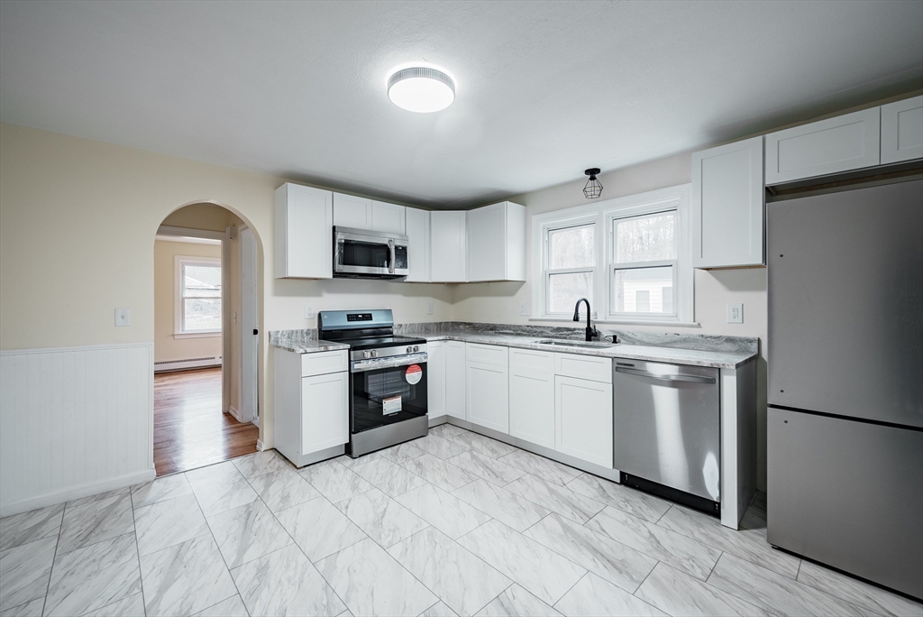 1174 Liberty Street Springfield, MA 01104 - Photo 4 of 34 a kitchen with granite countertop a refrigerator stove top oven and sink
