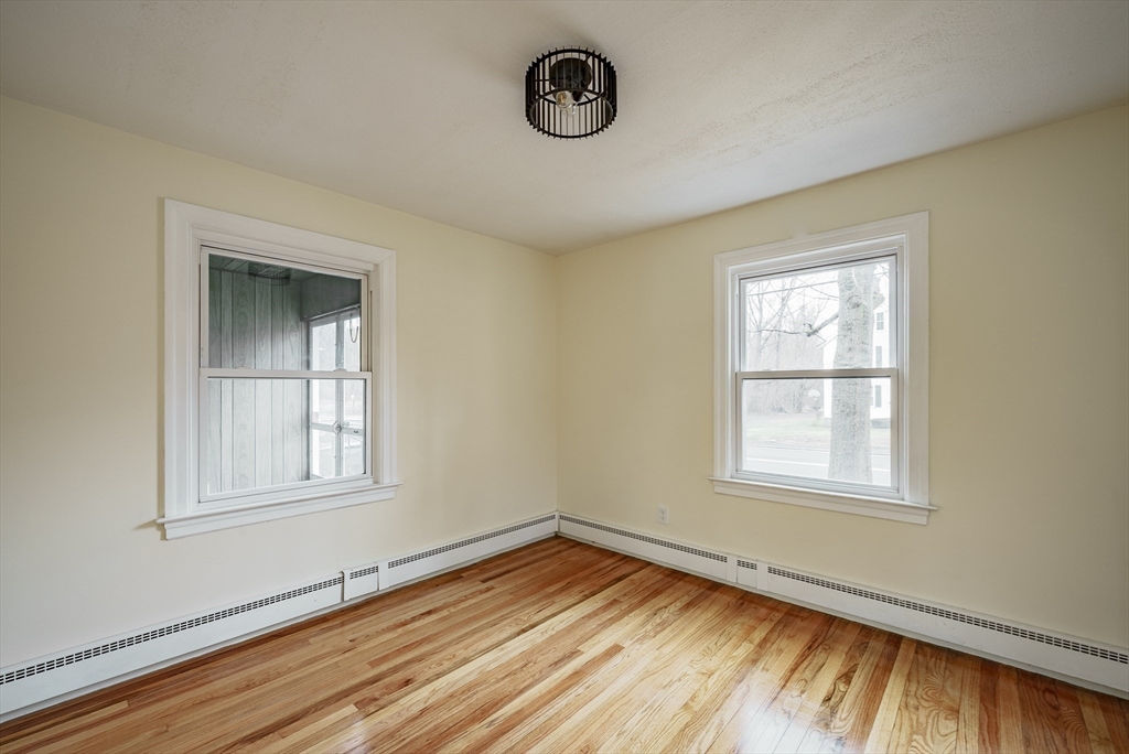 1174 Liberty Street Springfield, MA 01104 - Photo 7 of 34 a view of an empty room with wooden floor and a window