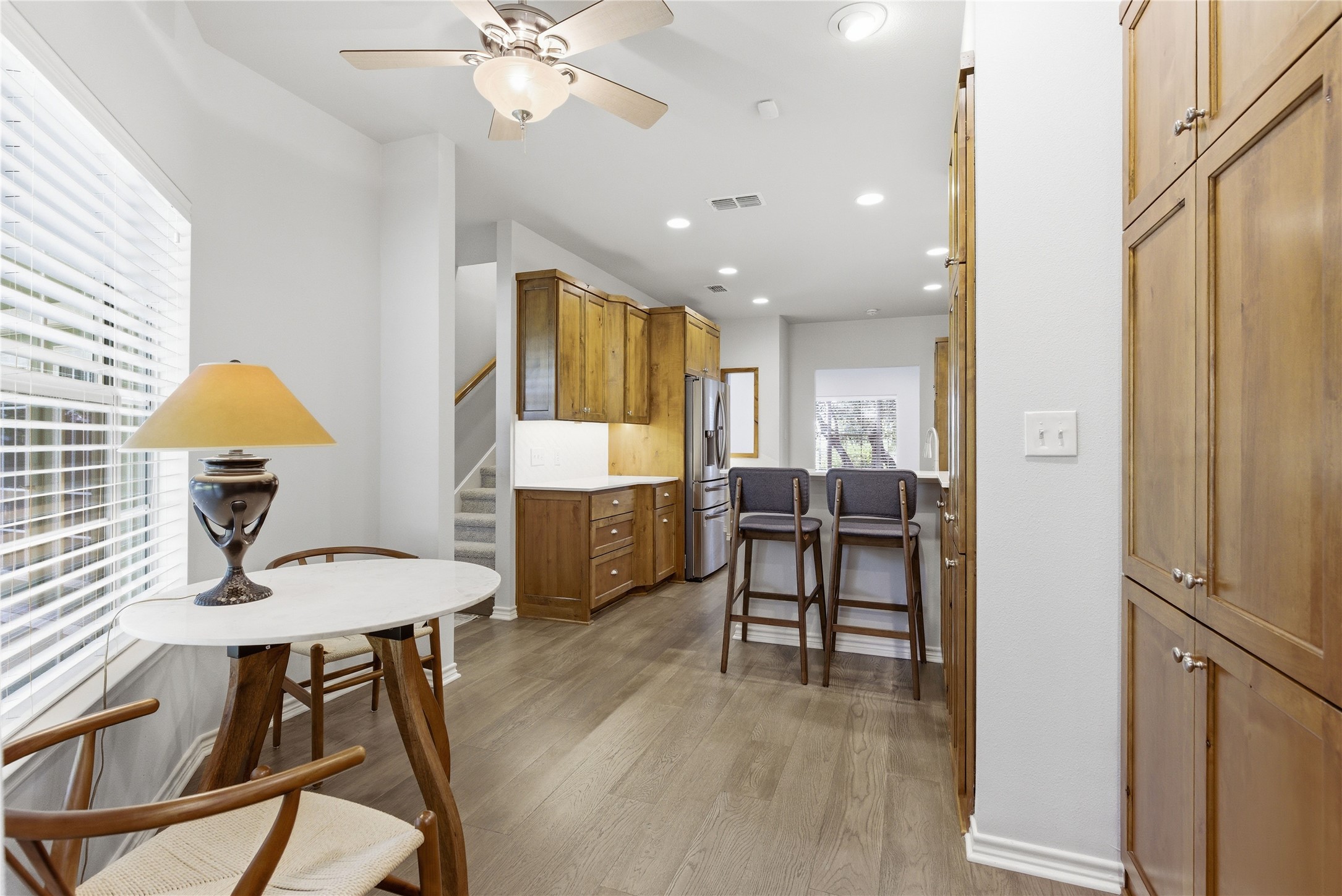 1204 Orlando Road Austin, TX 78733 - Photo 6 of 40 A well-lit kitchen featuring rich wooden cabinetry and a functional breakfast bar.