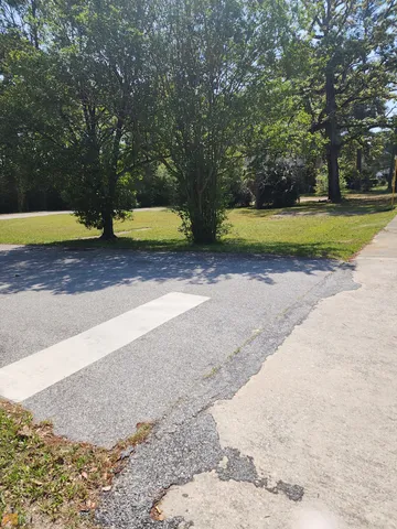 a view of yard with swimming pool and trees