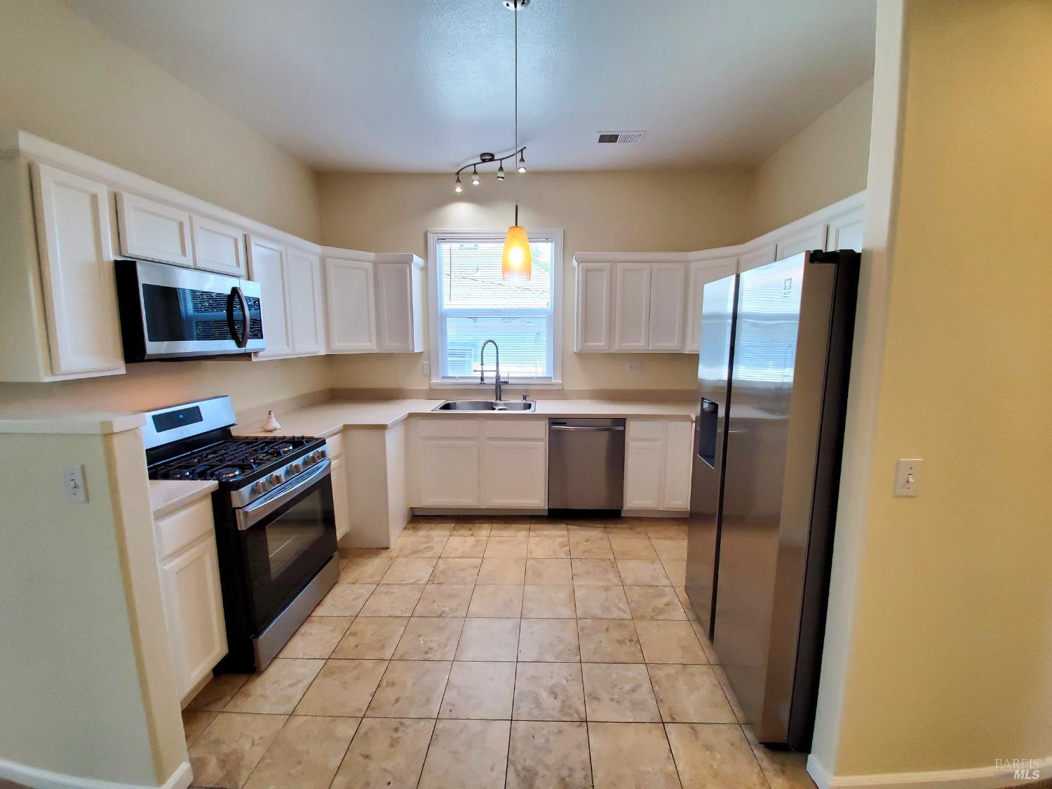 448 Sebastopol Avenue Santa Rosa, CA 95401 - Photo 13 of 21 a kitchen with stainless steel appliances granite countertop a refrigerator a sink a stove a microwave and island