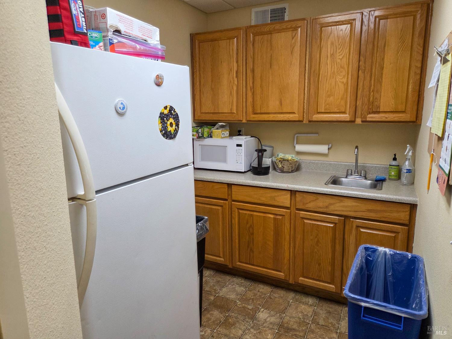 448 Sebastopol Avenue Santa Rosa, CA 95401 - Photo 7 of 21 a kitchen with refrigerator and cabinets
