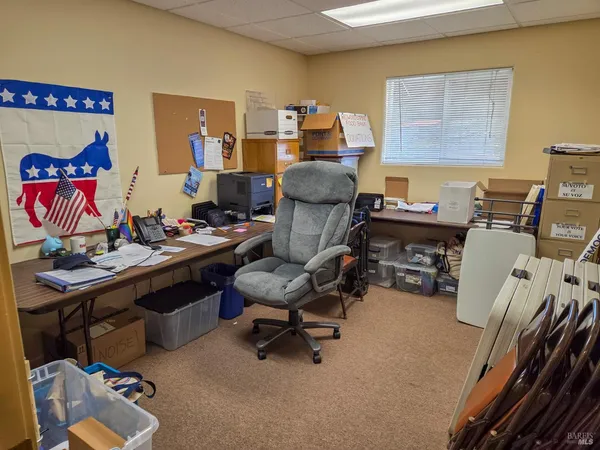 a work room with furniture and rug