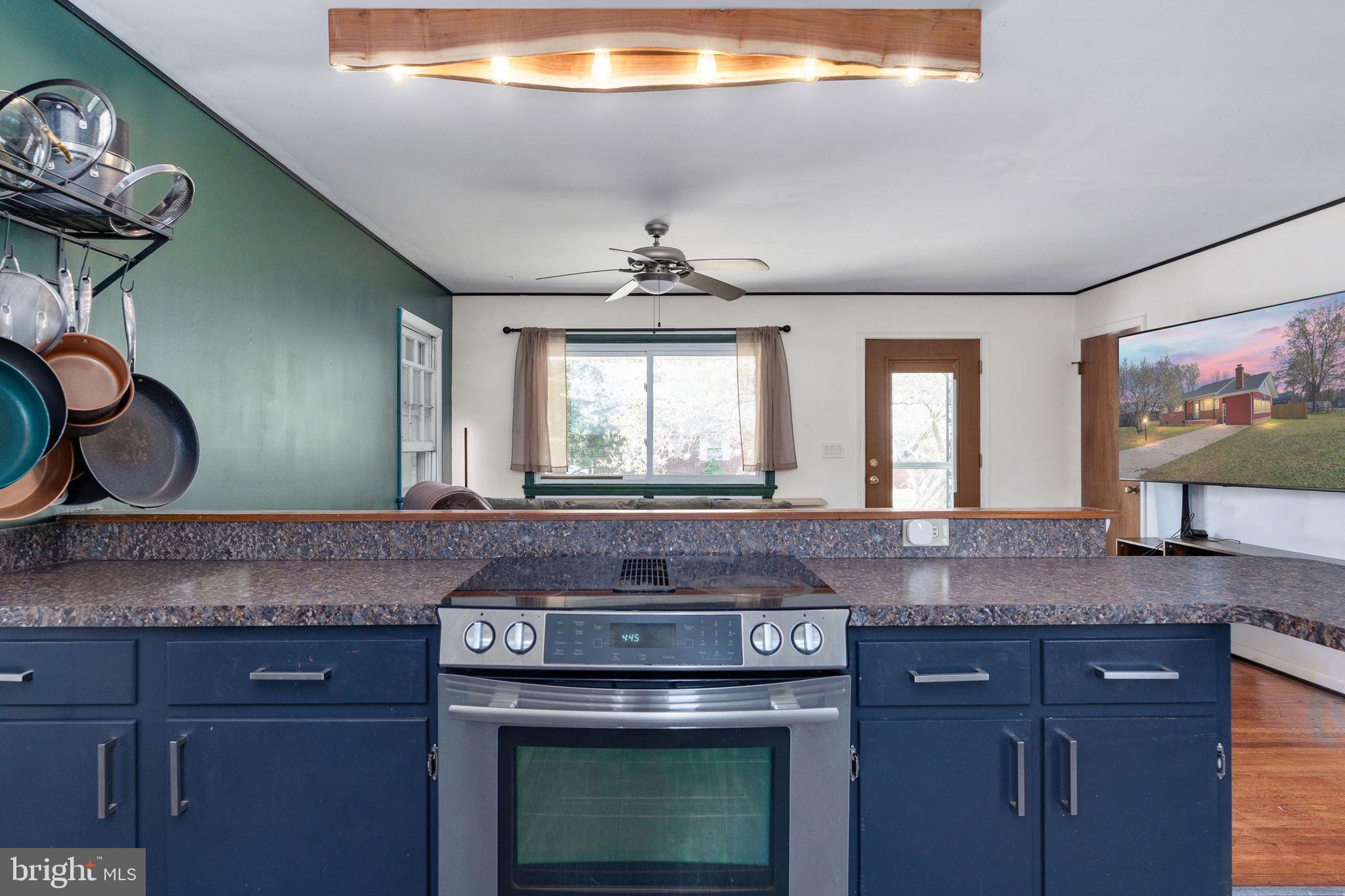 160 12th Street Colonial Beach, VA 22443 - Photo 17 of 60 a kitchen with granite countertop a sink and a window