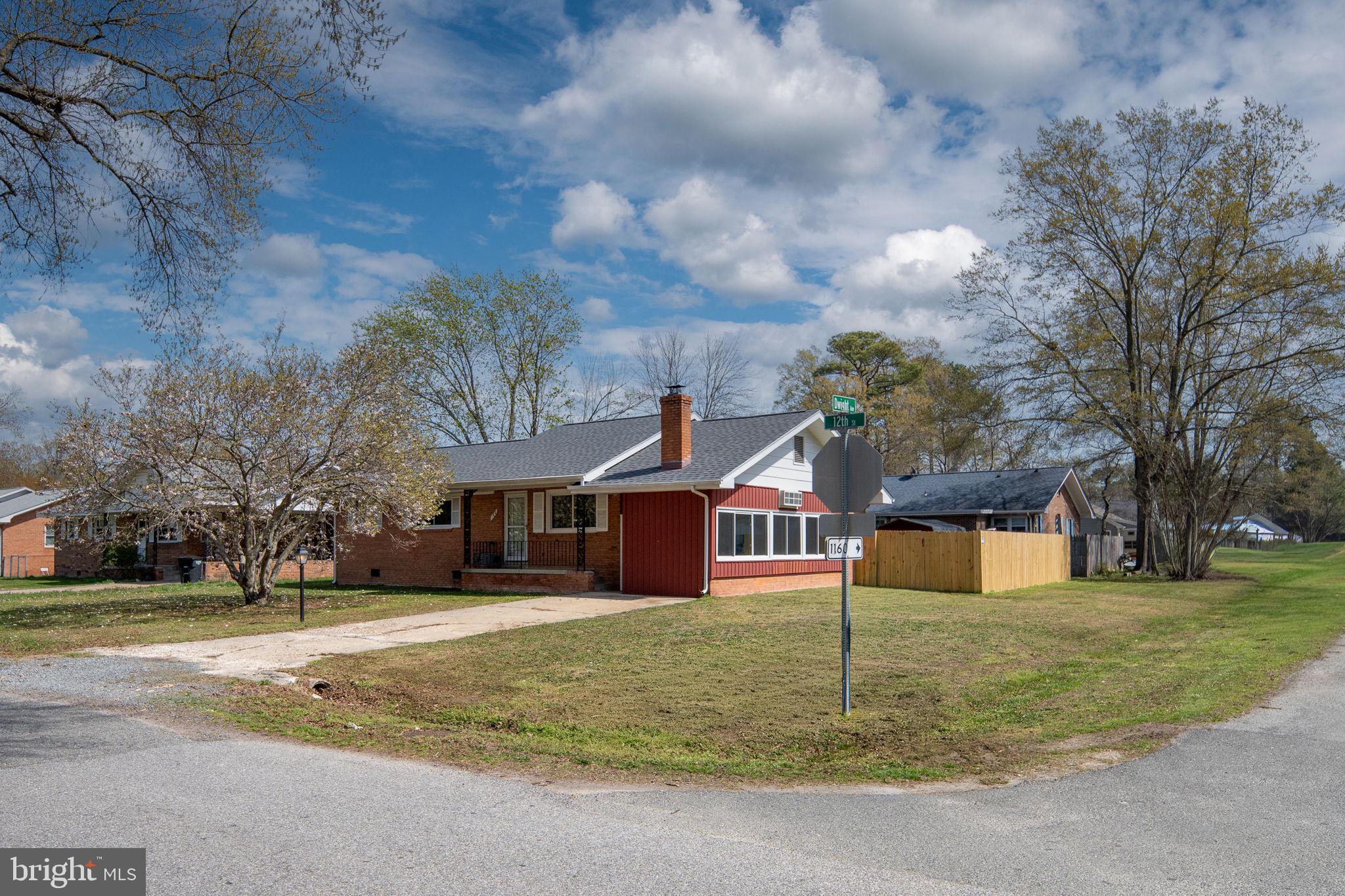 160 12th Street Colonial Beach, VA 22443 - Photo 2 of 60 a house that has a tree in front of it
