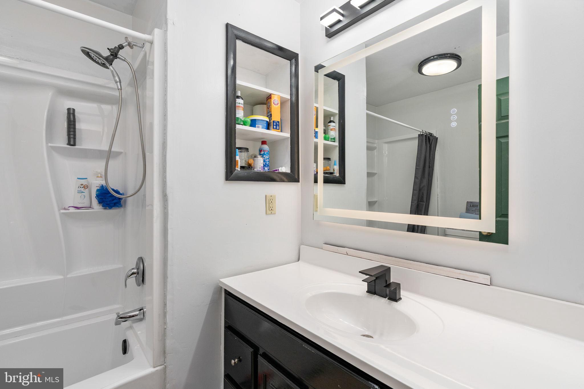 160 12th Street Colonial Beach, VA 22443 - Photo 23 of 60 a bathroom with a sink vanity and a mirror