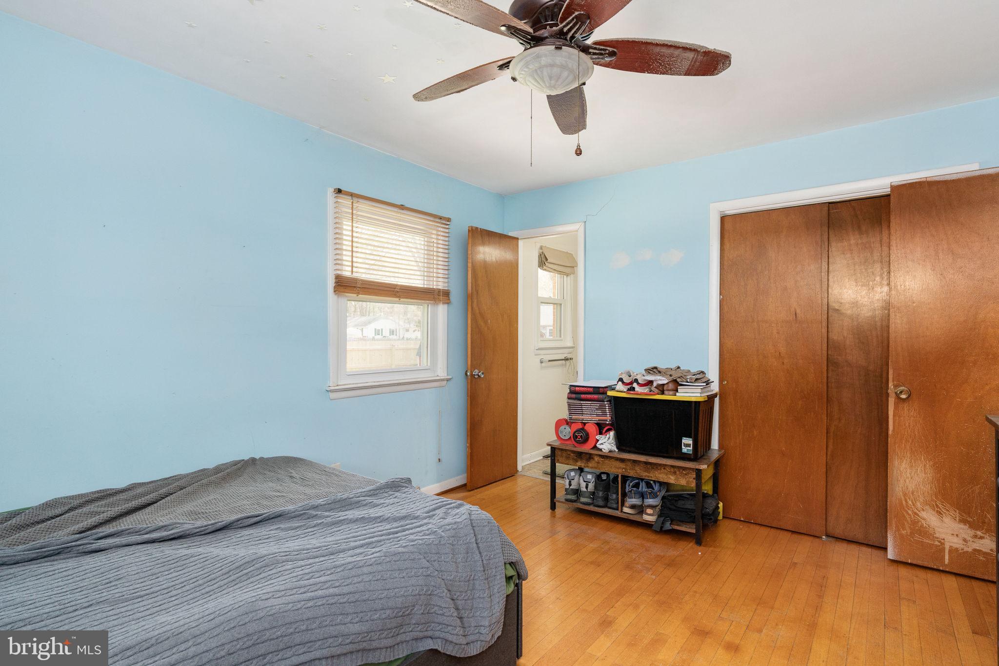 160 12th Street Colonial Beach, VA 22443 - Photo 24 of 60 a bedroom with a bed and a chandelier
