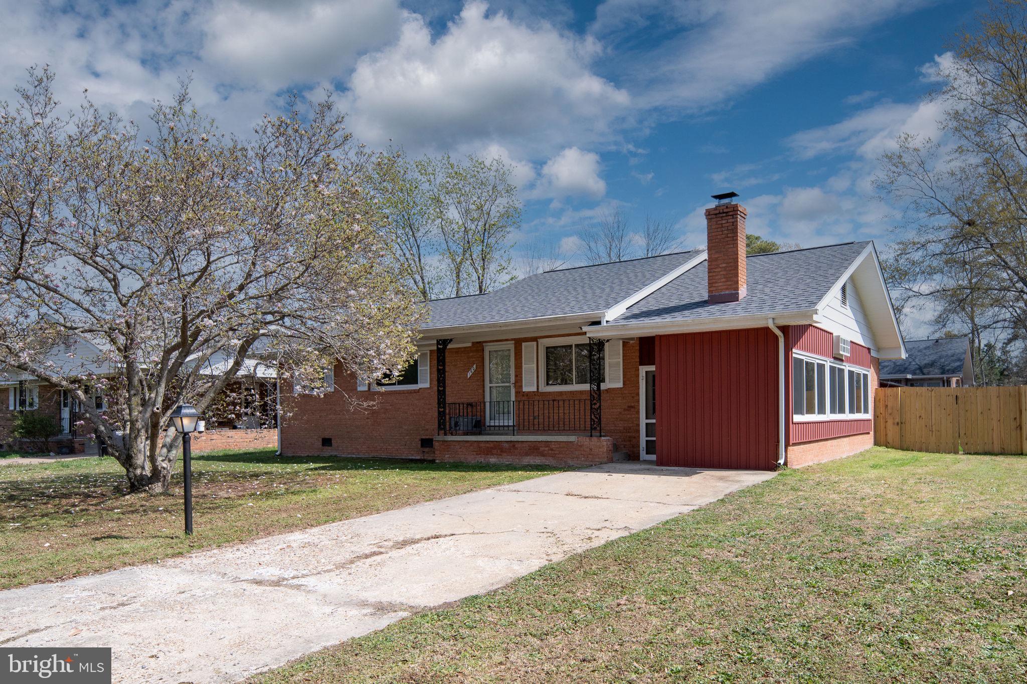 160 12th Street Colonial Beach, VA 22443 - Photo 5 of 60 a front view of a house with a yard and garage