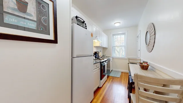 a kitchen with a refrigerator and a stove