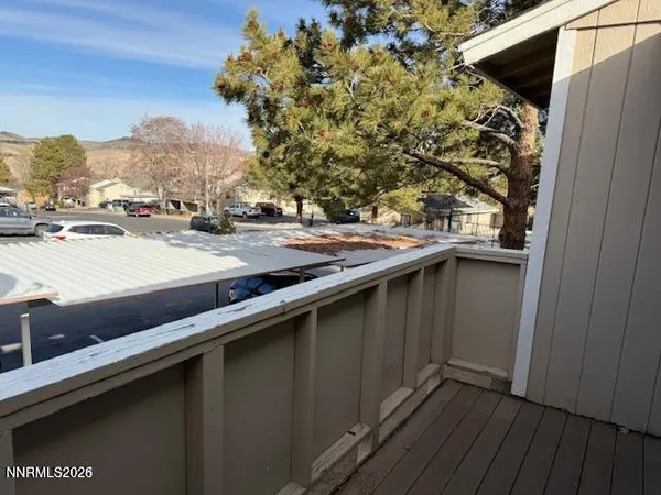 a view of balcony with wooden floor and fence