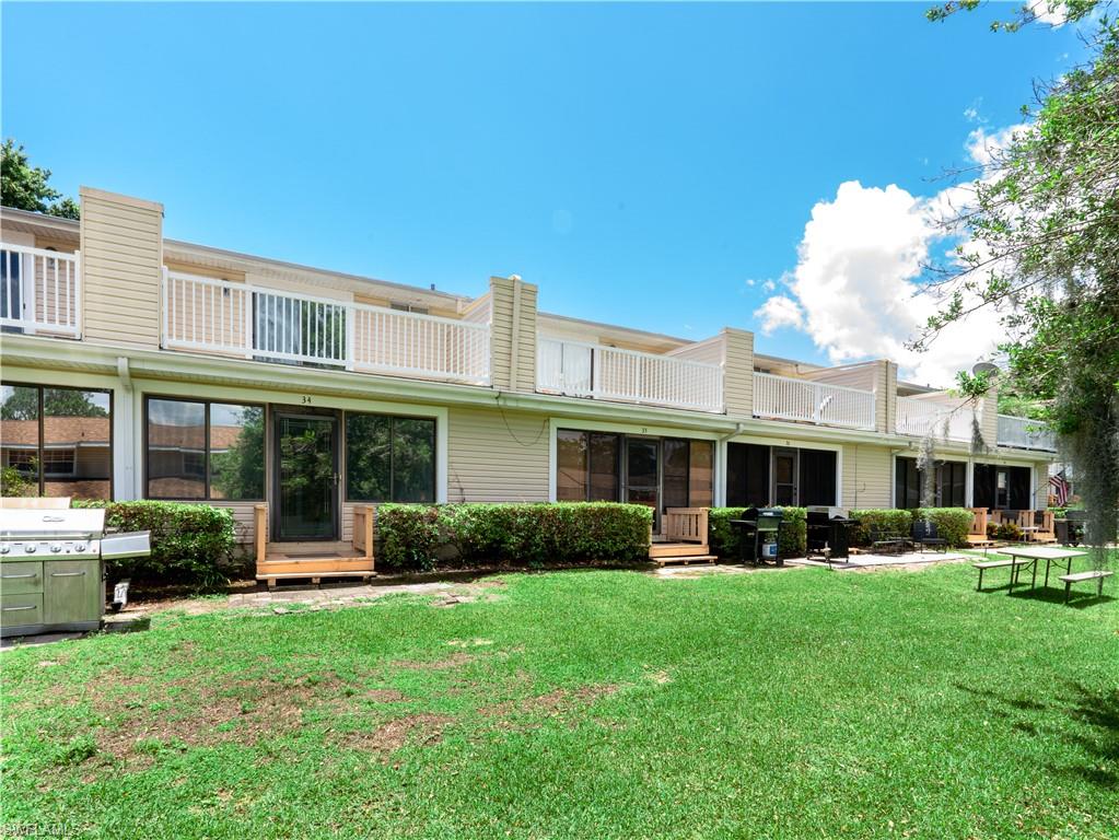 11001 Southeast Sunset Harbor Road, Unit 34 Summerfield, FL 34491 - Photo 24 of 31 Back of house with a lawn