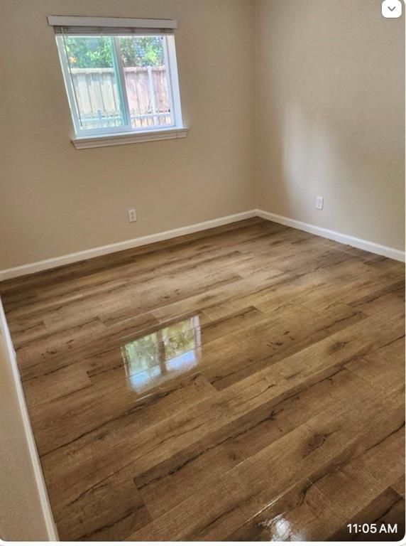4618 Reiger Avenue, Unit 103 Dallas, TX 75246 - Photo 4 of 7 a view of empty room with window and wooden floor