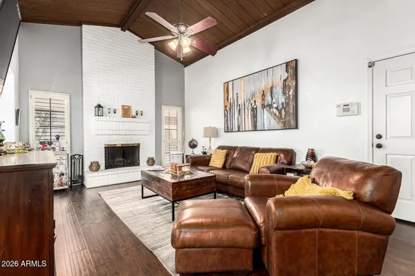 a living room with furniture a fireplace and a large window