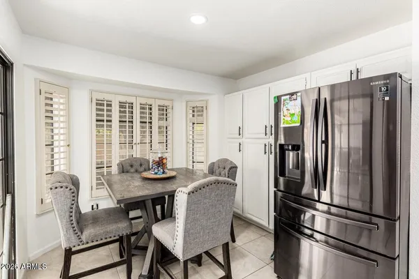a kitchen with stainless steel appliances granite countertop a refrigerator and a table