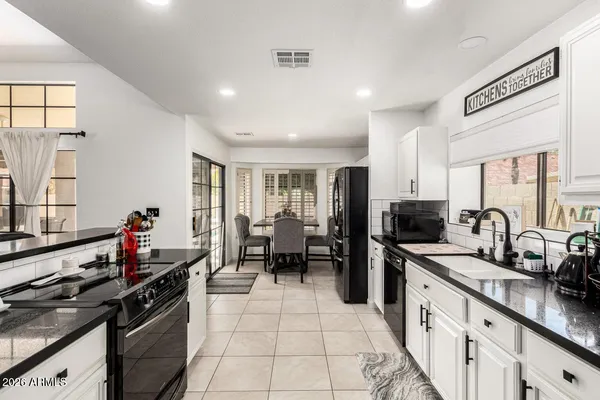 a kitchen with stainless steel appliances a stove sink microwave and cabinets