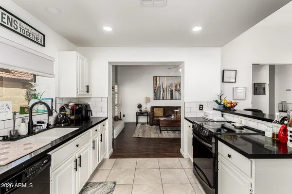 a kitchen with granite countertop a stove and a sink