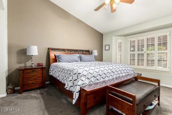 a bedroom with a bed and a night stand