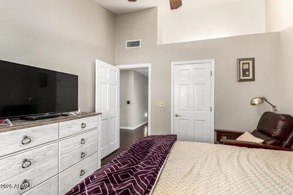 a bedroom with a bed and a flat screen tv
