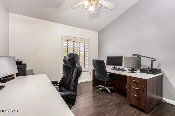 a view of a workspace with furniture and a window