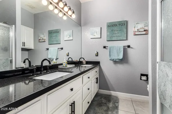 a spacious bathroom with a double vanity sink and a mirror