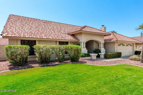 a front view of a house with a yard and porch