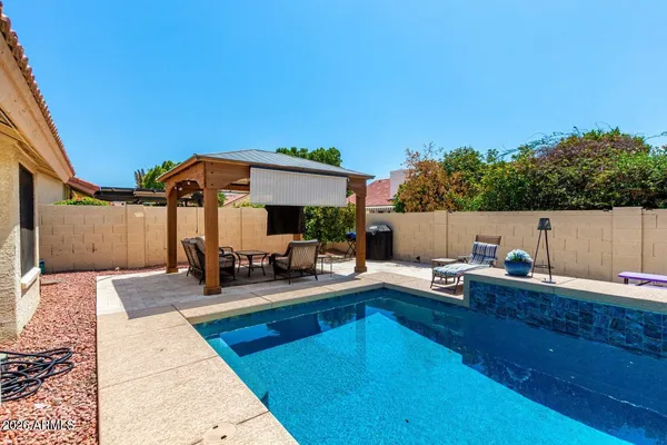 a view of a patio with swimming pool table and chairs