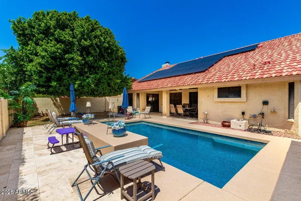 a view of a patio with chairs and potted plants