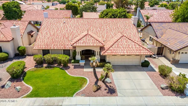 a view of a house with backyard sitting area and garden