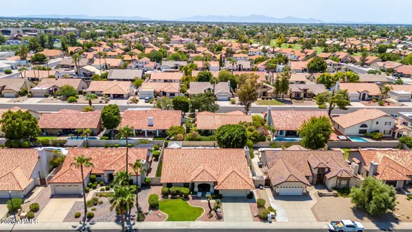 an aerial view of residential houses with outdoor space