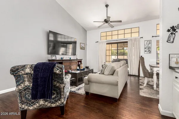 a living room with furniture a window and a flat screen tv