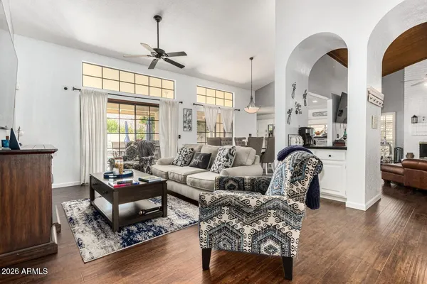 a living room with furniture fireplace and a large window