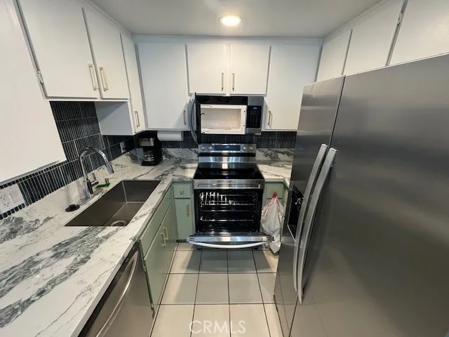 a kitchen with a sink stove and refrigerator