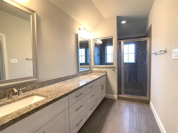 a bathroom with a double vanity sink and a mirror
