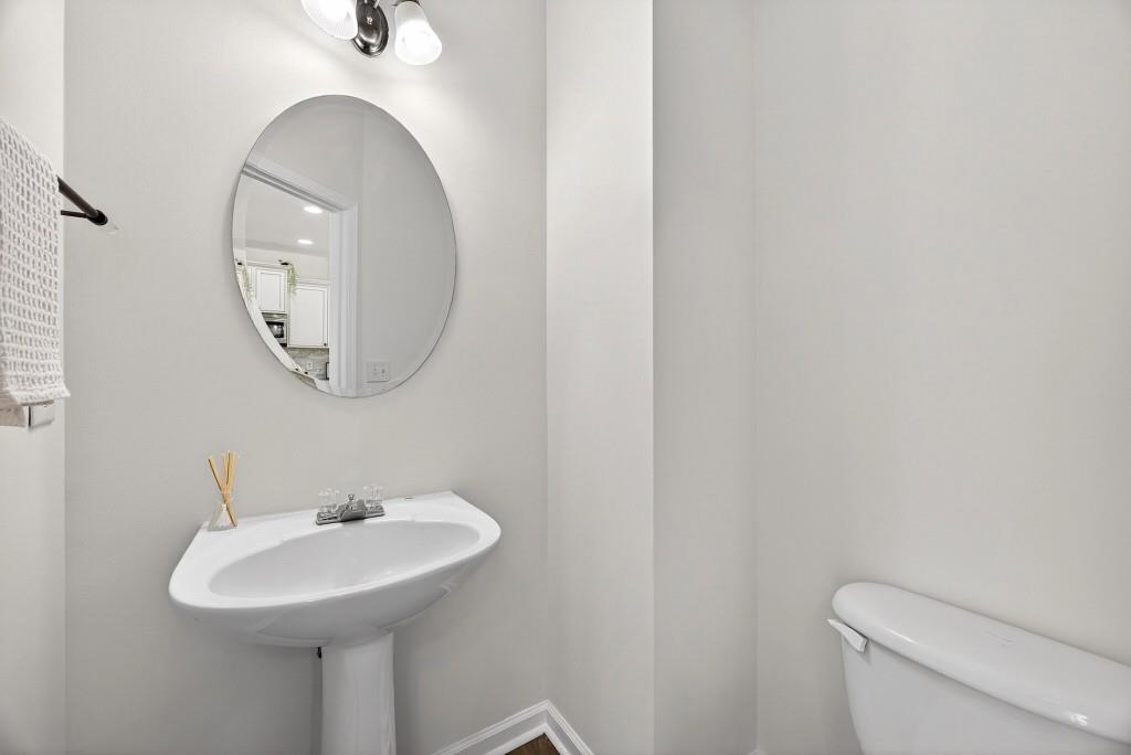 1646 Austin Meadows Drive Decatur, GA 30032 - Photo 11 of 29 a bathroom with a sink a mirror and a toilet