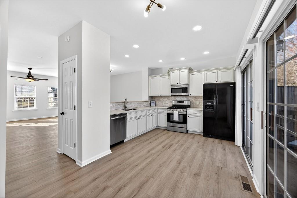 1646 Austin Meadows Drive Decatur, GA 30032 - Photo 12 of 29 a kitchen with a refrigerator and a stove top oven