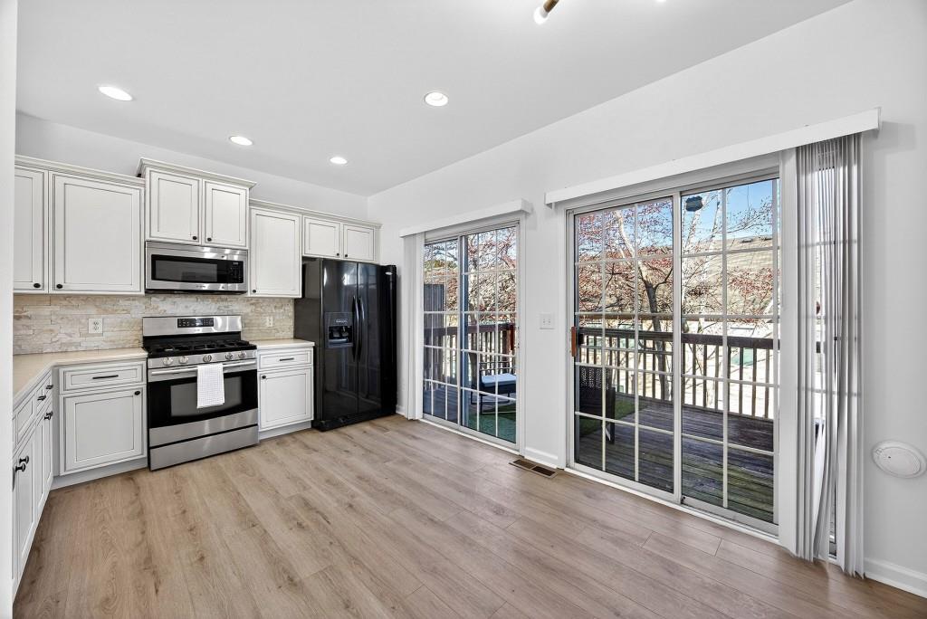 1646 Austin Meadows Drive Decatur, GA 30032 - Photo 14 of 29 a kitchen with stainless steel appliances a refrigerator sink and microwave