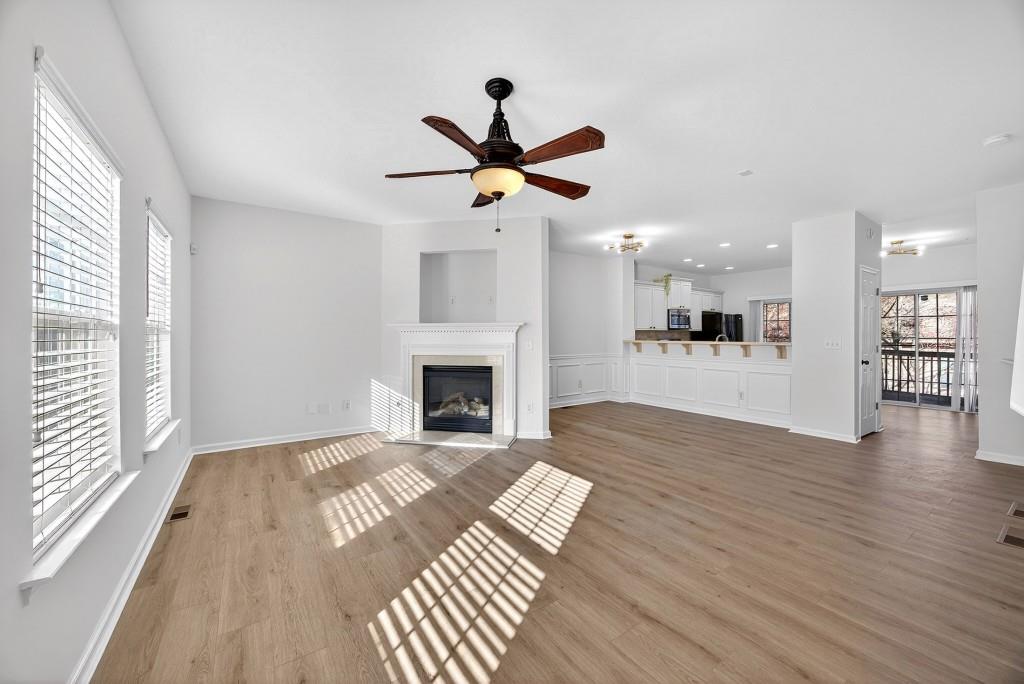 1646 Austin Meadows Drive Decatur, GA 30032 - Photo 16 of 29 a view of a livingroom with a fireplace a ceiling fan and wooden floor