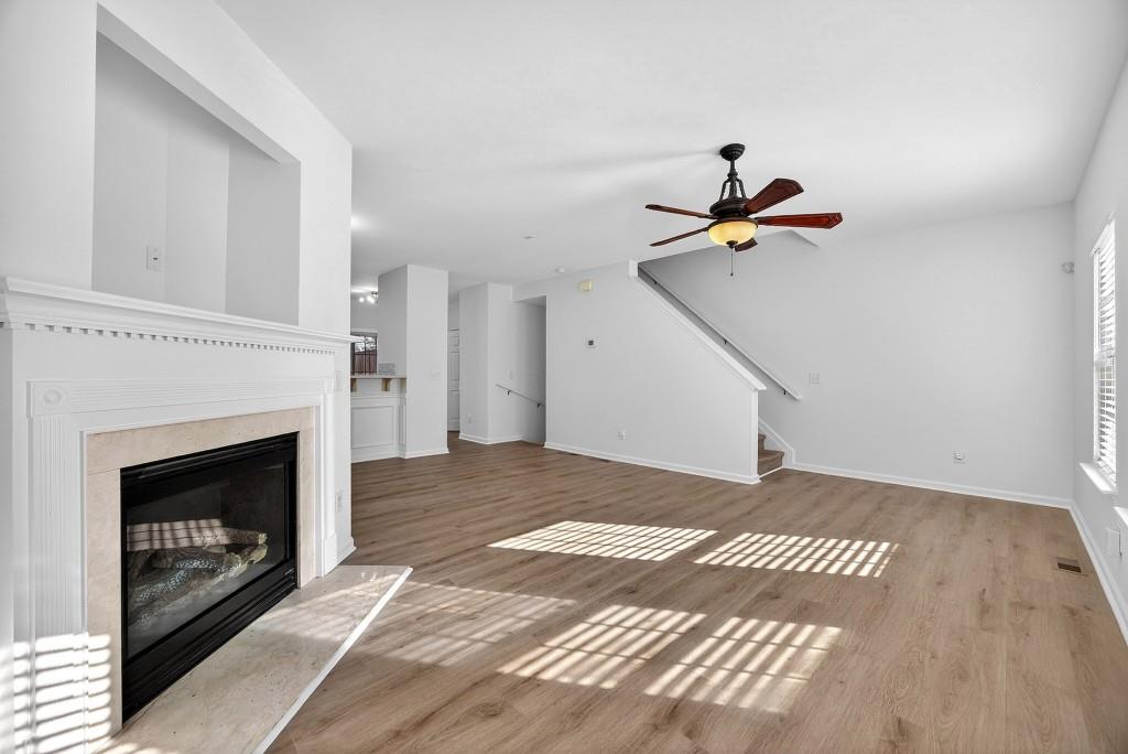 1646 Austin Meadows Drive Decatur, GA 30032 - Photo 18 of 29 a view of an empty room with stairs and a fireplace