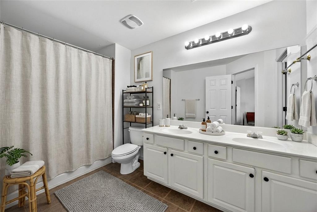 1646 Austin Meadows Drive Decatur, GA 30032 - Photo 21 of 29 a bathroom with a double vanity sink toilet and a mirror