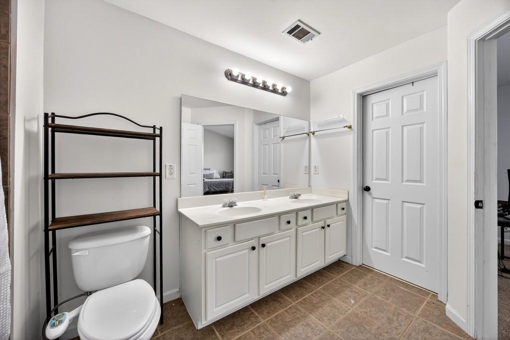 1646 Austin Meadows Drive Decatur, GA 30032 - Photo 22 of 29 a bathroom with a toilet a sink and a mirror