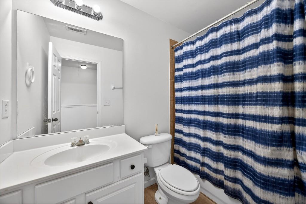 1646 Austin Meadows Drive Decatur, GA 30032 - Photo 24 of 29 a bathroom with a sink a toilet a shower and a mirror
