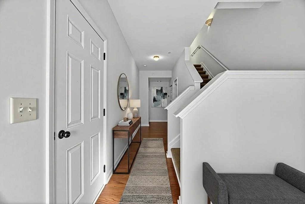 1646 Austin Meadows Drive Decatur, GA 30032 - Photo 4 of 29 a hallway with wooden floor stairs and windows