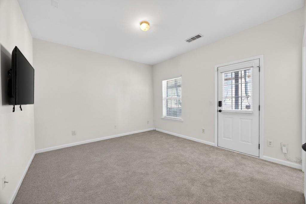 1646 Austin Meadows Drive Decatur, GA 30032 - Photo 7 of 29 an empty room with windows and fireplace