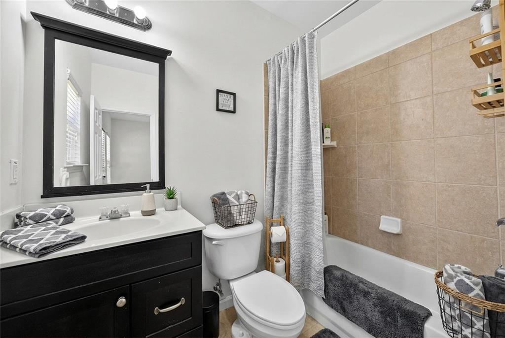 1646 Austin Meadows Drive Decatur, GA 30032 - Photo 8 of 29 a bathroom with a sink a toilet a shower and a mirror