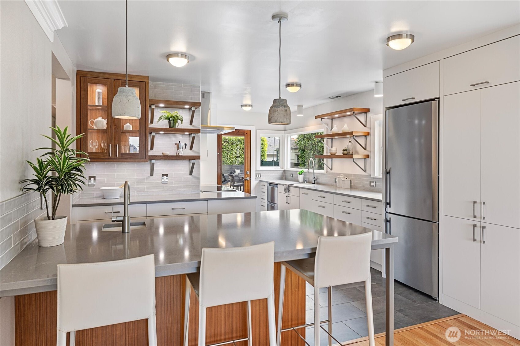 1940 Edgemont Place West Seattle, WA 98199 - Photo 11 of 37 a kitchen with a table chairs refrigerator and wooden floor