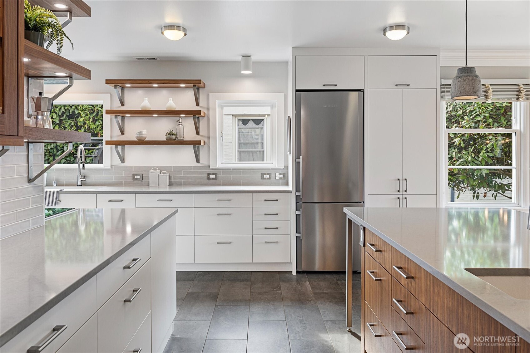 1940 Edgemont Place West Seattle, WA 98199 - Photo 13 of 37 a kitchen with white cabinets and stainless steel appliances