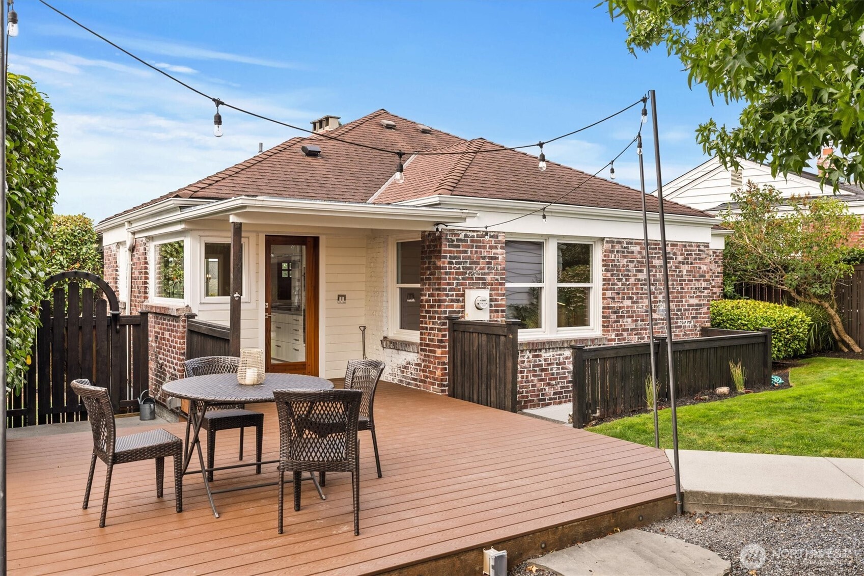 1940 Edgemont Place West Seattle, WA 98199 - Photo 26 of 37 a view of a house with a chairs and table in a patio