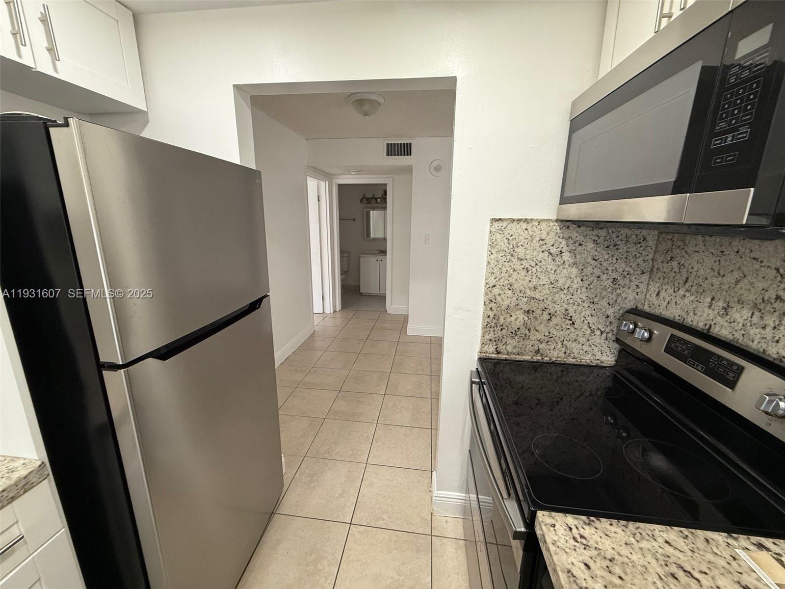 17011 North Bay Road, Unit 204 Sunny Isles Beach, FL 33160 - Photo 37 of 43 a kitchen with a refrigerator and a stove