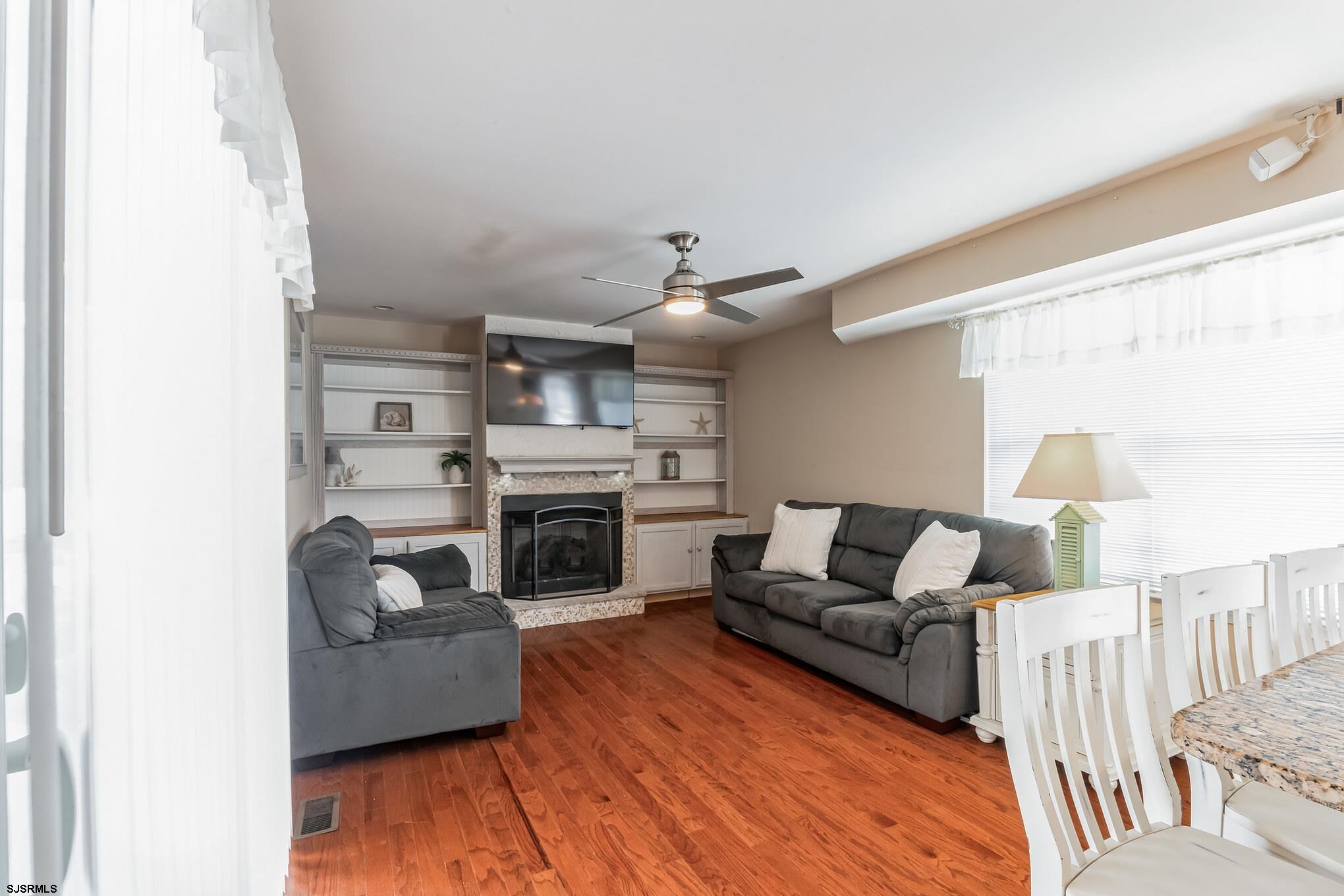 1 MacDonald Place Brigantine, NJ 08203 - Photo 12 of 36 a living room with furniture and a fireplace