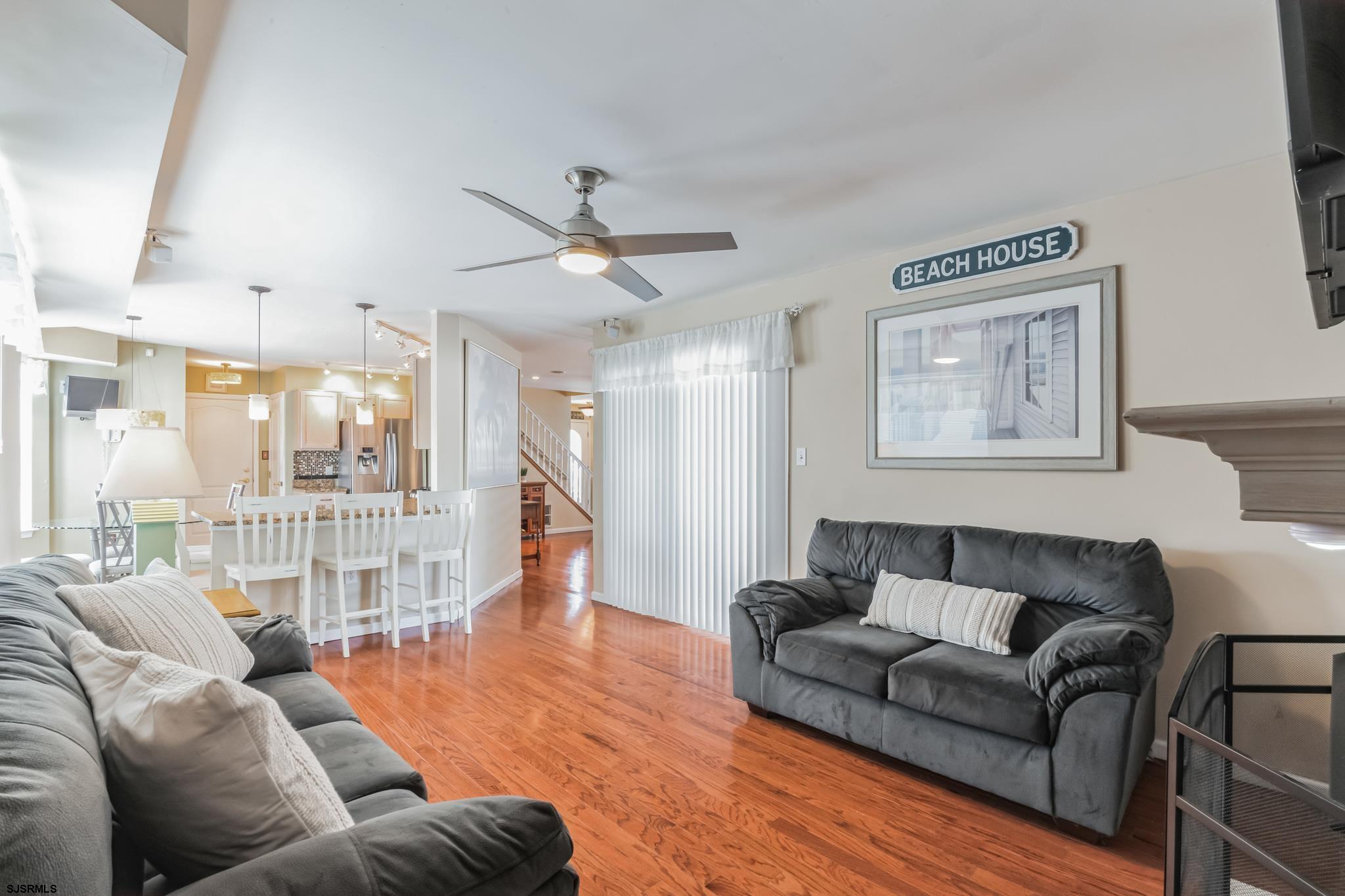 1 MacDonald Place Brigantine, NJ 08203 - Photo 13 of 36 a living room with furniture a ceiling fan and a large window